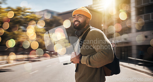 Image of City, travel and man with banner, walking and travel with student, fashion and casual outfit. Person, stylish and guy on the road, outdoor and bokeh with a cap, trendy and hipster with stylish outfit