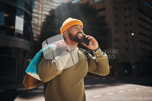 Image of Man, phone call and shopping in city with travel, walking and talking of student deal, discount or online sale in street. Happy african person with retail bag and mobile communication or outdoor chat