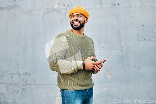 Image of Cellphone, happy and young man by wall networking on social media, mobile app or the internet. Technology, smile and male person from Colombia scroll on website with phone in city by gray background.
