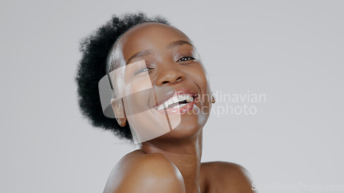 Image of Black woman, smiling and beauty with glowing skin, face and afro hair for cosmetics, dermatology and natural makeup. Body wellness, moisturised and healthy with clean aesthetic, happiness and fresh