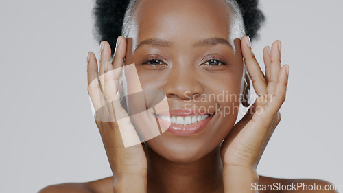 Image of Face touch, skincare and happy black woman in studio isolated on a gray background for dermatology. Portrait, hands and natural beauty cosmetics of model in spa facial treatment, wellness and health