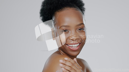 Image of Portrait, beauty and smile with a happy black woman in studio on a gray background for natural wellness. Skincare, aesthetic or cosmetics with a happy young model closeup for antiaging face treatment