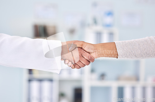 Image of Doctor, people and handshake in partnership, meeting or deal for healthcare agreement at hospital. Closeup of medical worker shaking hands with patient in thank you, welcome or introduction at clinic