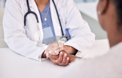 Image of Healthcare, holding hands and doctor with woman in clinic for support. empathy or care. Checkup, discussion and closeup of female medical worker with sympathy for African patient in medicare hospital