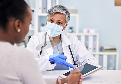 Image of Senior woman, doctor and tablet for consultation, checkup or diagnosis with mask and patient at hospital. Mature female person, medical nurse or surgeon consulting customer with technology at clinic