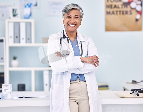 Image of Happy senior woman, doctor and professional with arms crossed in confidence for healthcare at hospital. Portrait of mature female person, medical expert or surgeon smile for health service at clinic