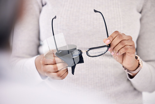 Image of Person hands, cleaning glasses with cloth and vision, hygiene and maintenance, health and prescription lens with frame. Eyewear, fabric and improve eyesight, eye care and wellness with cleanliness