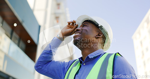 Image of Happy black man, architect and city with helmet for construction, architecture or building on site. African male person, engineer or engineer smile with hard hat for industrial safety in urban town