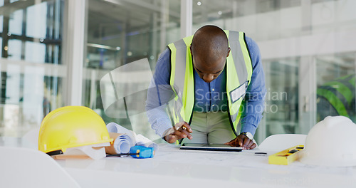 Image of Black man, tablet and check floor plan for construction or architect working in office, contractor and maintenance. Review digital blueprint for architecture project, productivity and design software