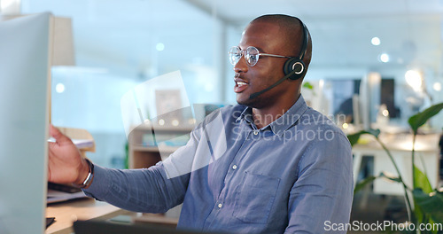 Image of Call centre, man and headset while talking in office for consultation, telemarketing or customer service. African, person or agent with assistance on website, support or sales with company database