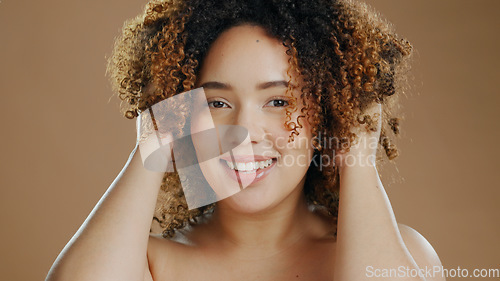 Image of Portrait of happy woman, model or natural beauty cosmetics for wellness in studio with smile. Skin glow, transformation or confident biracial female person with skincare or pride on brown background