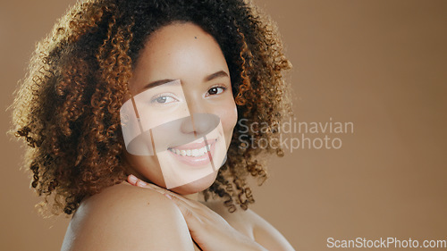 Image of Portrait of happy woman, natural beauty mockup space or cosmetics for wellness in studio with smile. Skin glow, pride or confident biracial female model with skincare results on a brown background