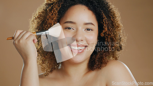 Image of Makeup, portrait or foundation by happy woman with brush in studio for beauty or wellness on brown background. Makeover, glamour or biracial girl model relax with cosmetics powder or application tool