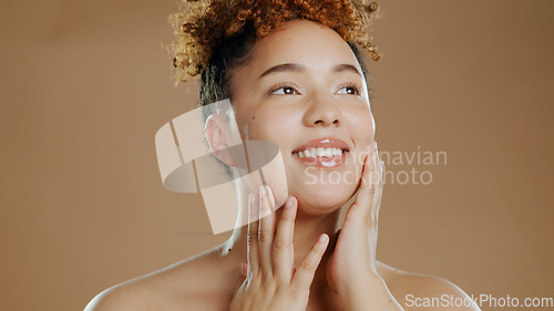 Image of Woman, beauty and touch face for skincare cosmetics in studio isolated on brown background. Hand, natural and happy model thinking in spa facial treatment for glow, health or wellness of smooth skin