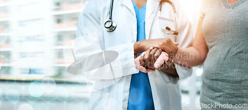 Image of Closeup, doctor and patient with support, holding hands and teamwork with lens flare, banner and healthcare. People, medical professional and woman with medicare, hospital and compassion with empathy