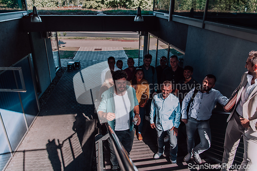 Image of A diverse group of businessmen and colleagues walking together by their workplace, showcasing collaboration and teamwork in the company.