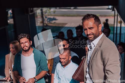 Image of A diverse group of businessmen and colleagues walking together by their workplace, showcasing collaboration and teamwork in the company.