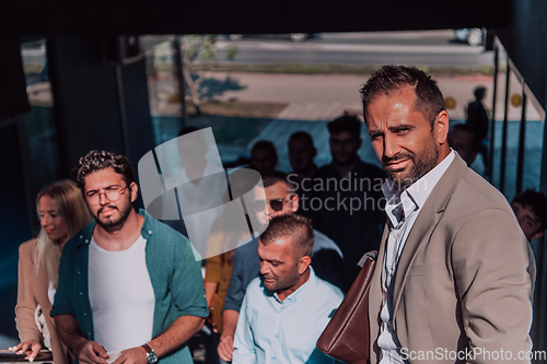 Image of A diverse group of businessmen and colleagues walking together by their workplace, showcasing collaboration and teamwork in the company.