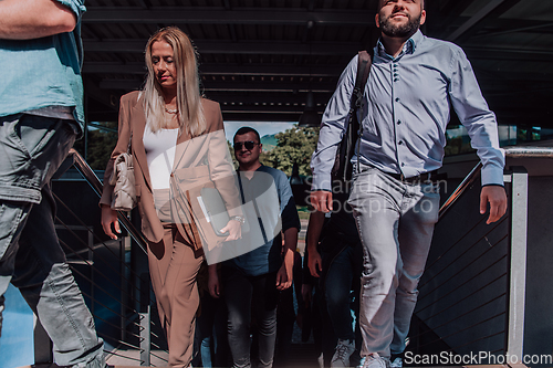 Image of A diverse group of businessmen and colleagues walking together by their workplace, showcasing collaboration and teamwork in the company.