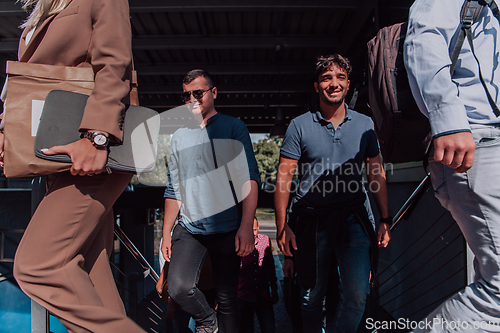 Image of A diverse group of businessmen and colleagues walking together by their workplace, showcasing collaboration and teamwork in the company.