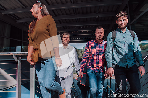 Image of A diverse group of businessmen and colleagues walking together by their workplace, showcasing collaboration and teamwork in the company.