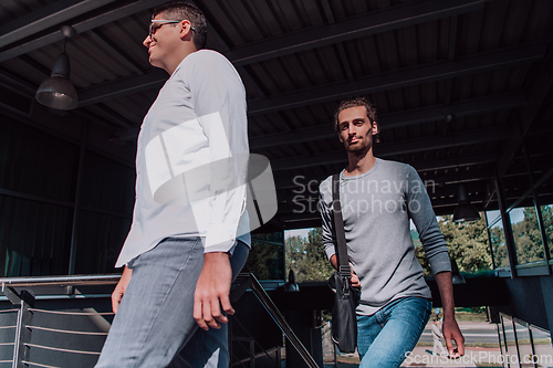 Image of A diverse group of businessmen and colleagues walking together by their workplace, showcasing collaboration and teamwork in the company.