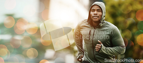 Image of Fitness, bokeh and black man running outdoor, exercise or training healthy body in the morning in winter. Sport, cardio and African athlete workout, jog for wellness or energy for endurance in nature