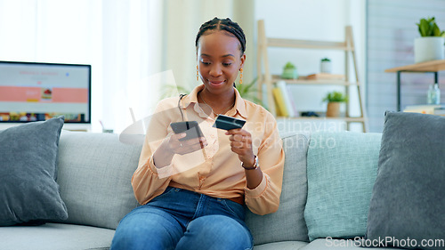 Image of Black woman, phone and credit card on sofa for payment, online shopping or fintech at home. Happy African female person in relax with debit or mobile smartphone for transaction, bank app or ecommerce
