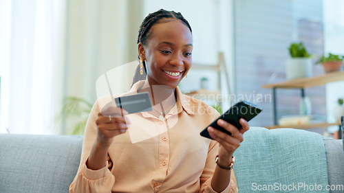 Image of Happy black woman, phone and credit card on sofa for payment, online shopping or fintech at home. African female person smile with debit and mobile smartphone for transaction, bank app or ecommerce