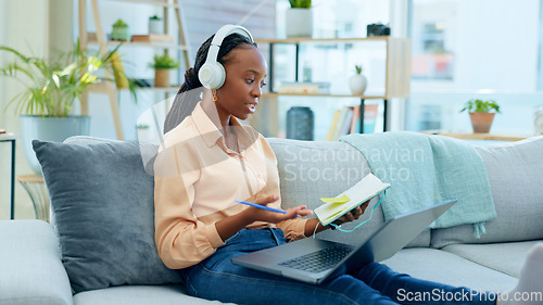 Image of African woman, student and laptop for online course on sofa, headphones and notes with thinking in home. Girl, reading and ideas with notebook, computer or headphones for study on video call on couch