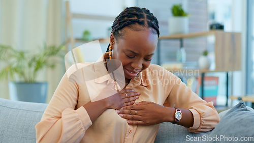 Image of Black woman, chest pain and heart attack with health at home, emergency and breathing issue with indigestion. Respiratory, pneumonia or tuberculosis, lungs or cardiovascular healthcare or anxiety
