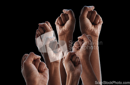 Image of Fist, group protest and together by black background for human rights, power or solidarity for equality. People, support and strong with hands, air or change for motivation, goal or fight for justice