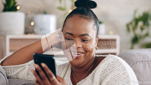 Image of Black woman, reading and using phone with smile in home with social media, mobile app and communication online. Funny, meme or person on couch streaming video or comedy on cellphone in living room