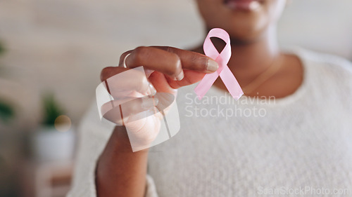 Image of Hand, person with pink ribbon and breast cancer awareness, health and support with care. Healthcare, campaign with symbol or icon, disease prevention with closeup of bow and wellness with sign