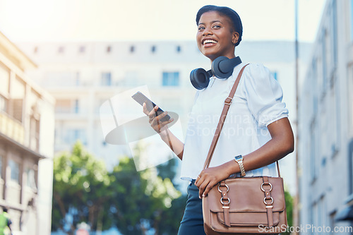 Image of Phone, walking and young woman in the city networking on social media, mobile app or the internet. Happy, technology and African female person scroll on cellphone and commuting in urban town street.