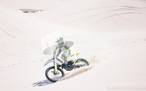 Image of Man, driving and motorbike on sand for sport, adventure or competition outdoor in summer and mockup space. Motorcycle, ride and athlete on dirt, dune or desert for race, danger and fearless challenge