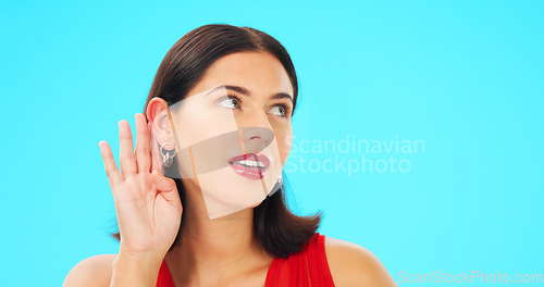 Image of Secret, gossip and woman in blue studio background for beauty and listening. Whisper, frame and privacy with makeup, headshot and isolated for cupping ear, rumour and thinking for spy, emoji or talk