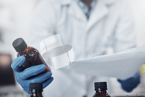 Image of Hands, bottle and science with a doctor man at work in a laboratory for research or medical innovation. Healthcare, analytics and vaccine with a medicine professional working on development in a lab