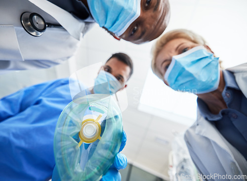 Image of Group, doctor and surgery with anesthesia, below and hospital theater for wellness, health and innovation. Doctors, teamwork or nurse with medical safety mask, help and clinic service in Los Angeles