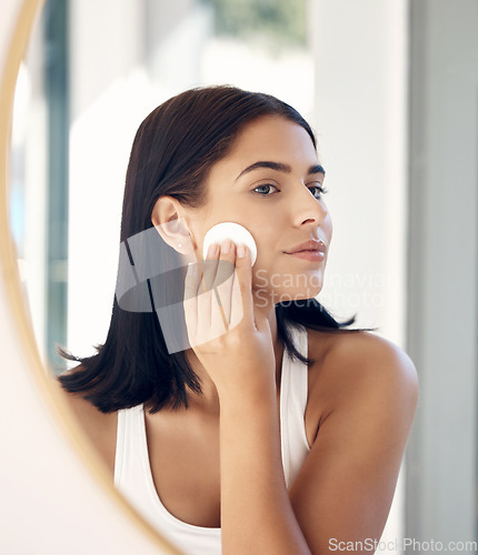 Image of Beauty, mirror reflection and woman with cotton pad for facial cleaning, makeup removal or home skincare routine. Health, wellness or face of model girl with cosmetics product for self care treatment