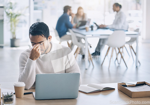 Image of Stress, laptop and burnout with a business man at work on his laptop while suffering from a headache. Compliance, computer and anxiety with a male employee working while struggling with fatigue