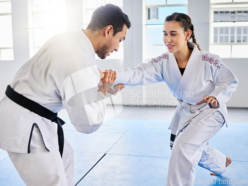 Image of Man, karate and coach training woman in fitness, workout and exercise class for competition, black belt fight or self defense. Sports athlete, judo teacher and student in taekwondo power punch goals