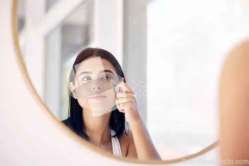 Image of Mirror reflection of woman with skincare cream, spa lotion or dermatology ointment for melasma or acne treatment. Bathroom facial routine, healthcare and face of girl apply cosmetics beauty product