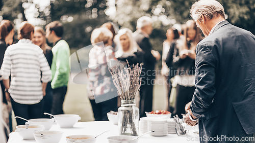 Image of Banquet lunch break at conference meeting on hotel terrace.