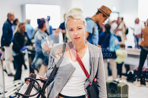 Image of Female traveller waiting in airport terminal.