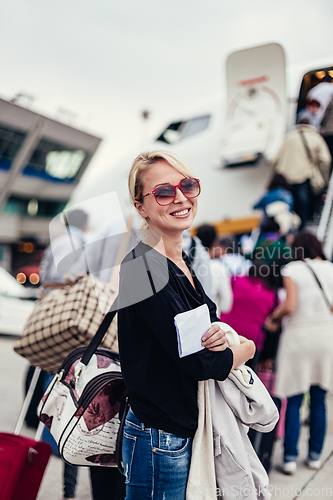 Image of Woman boarding airplane.