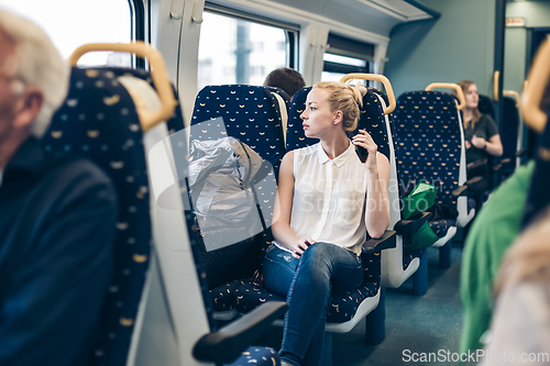 Image of Woman travelling by train.