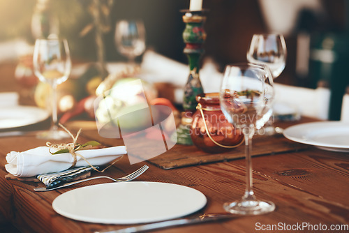 Image of Table, wine glass and plate for festive holiday meal, drinking and celebration with blurred background. Fine dining, party and glass for wine at feast, dinner or lunch in home, house or restaurant