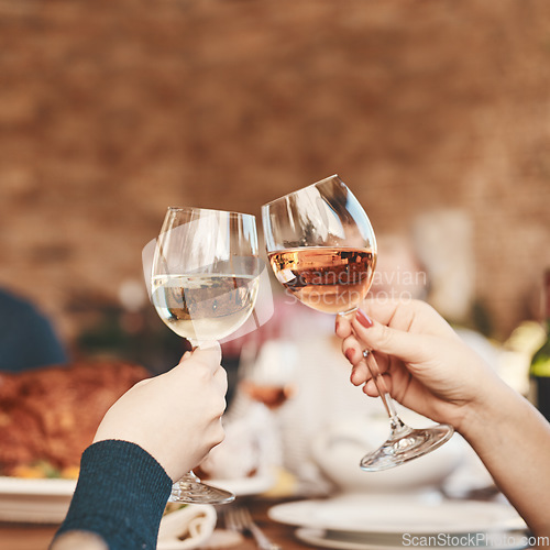 Image of Hands, wine glass and toast with wine at party, holiday celebration and couple drinking. Dinner party, celebrate together with food, drink and celebrating Christmas, Thanksgiving or anniversary.