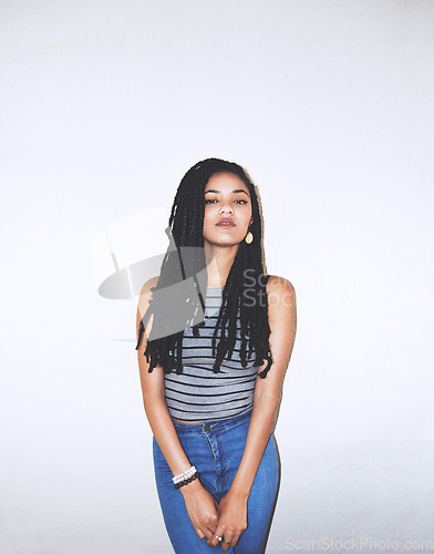 Image of Black woman, fashion portrait and beauty with braids, elegant and hipster female in white studio background with mockup space. Young model, cool and serious with trendy stylish clothes with mock up